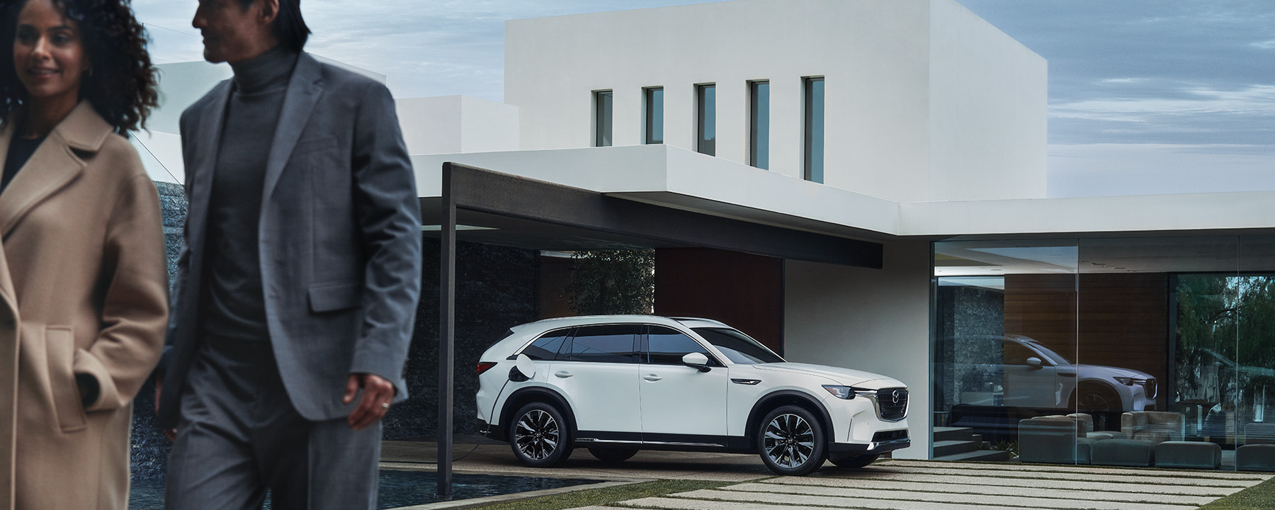 Mantenimiento de los autos eléctricos 101  –  Un Mazda CX-90 PHEV estacionado fuera de una casa