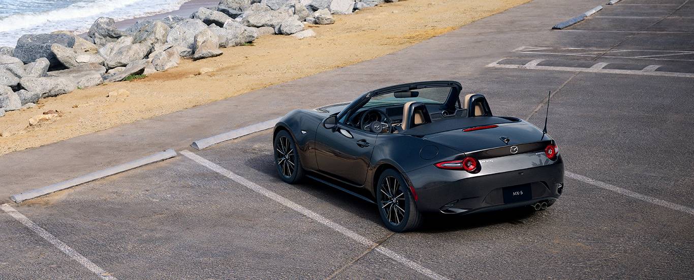  2024 Mazda MX-5 Miata parked by ocean. 