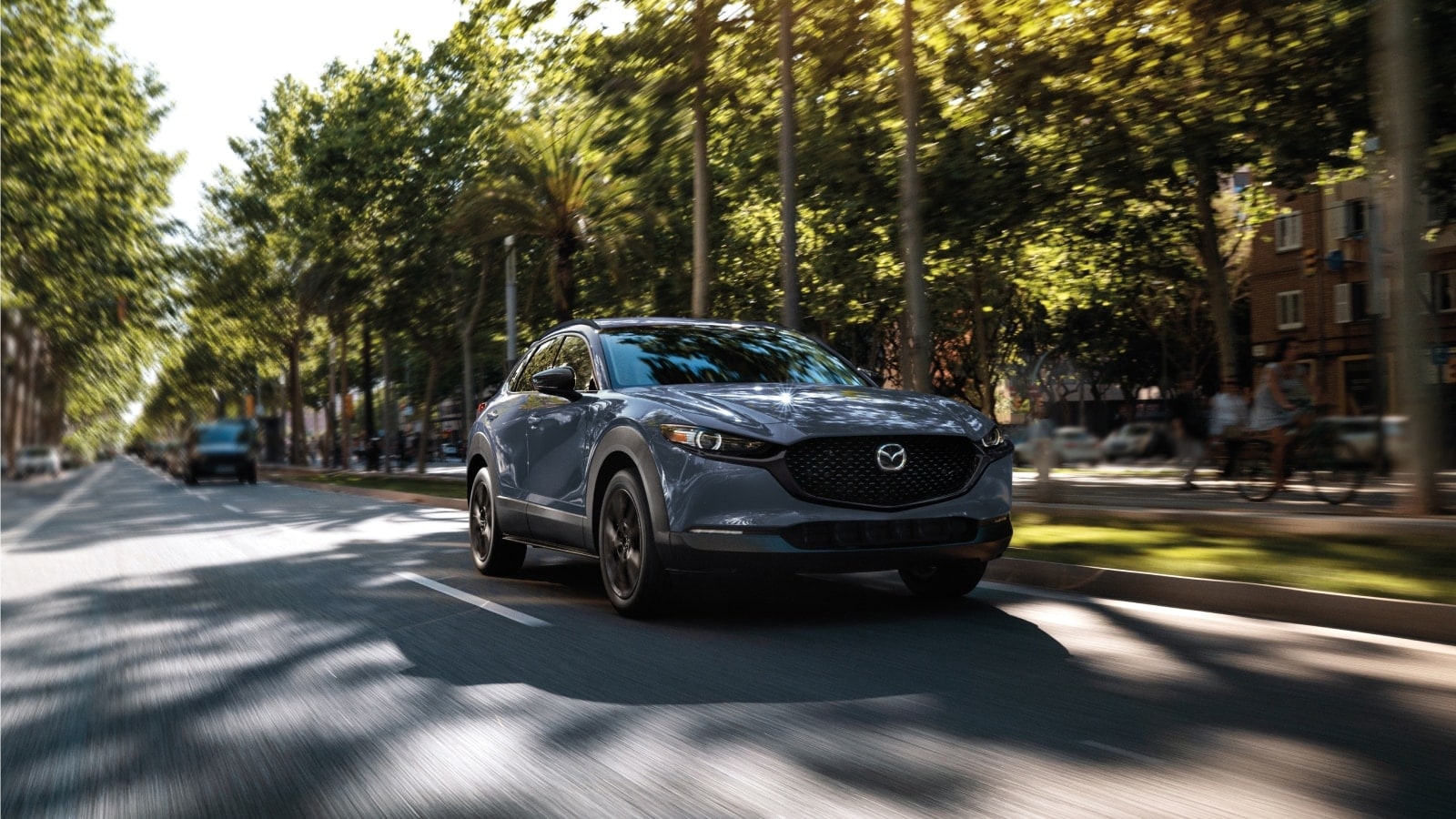2025 Mazda CX-30 driving through neighborhood