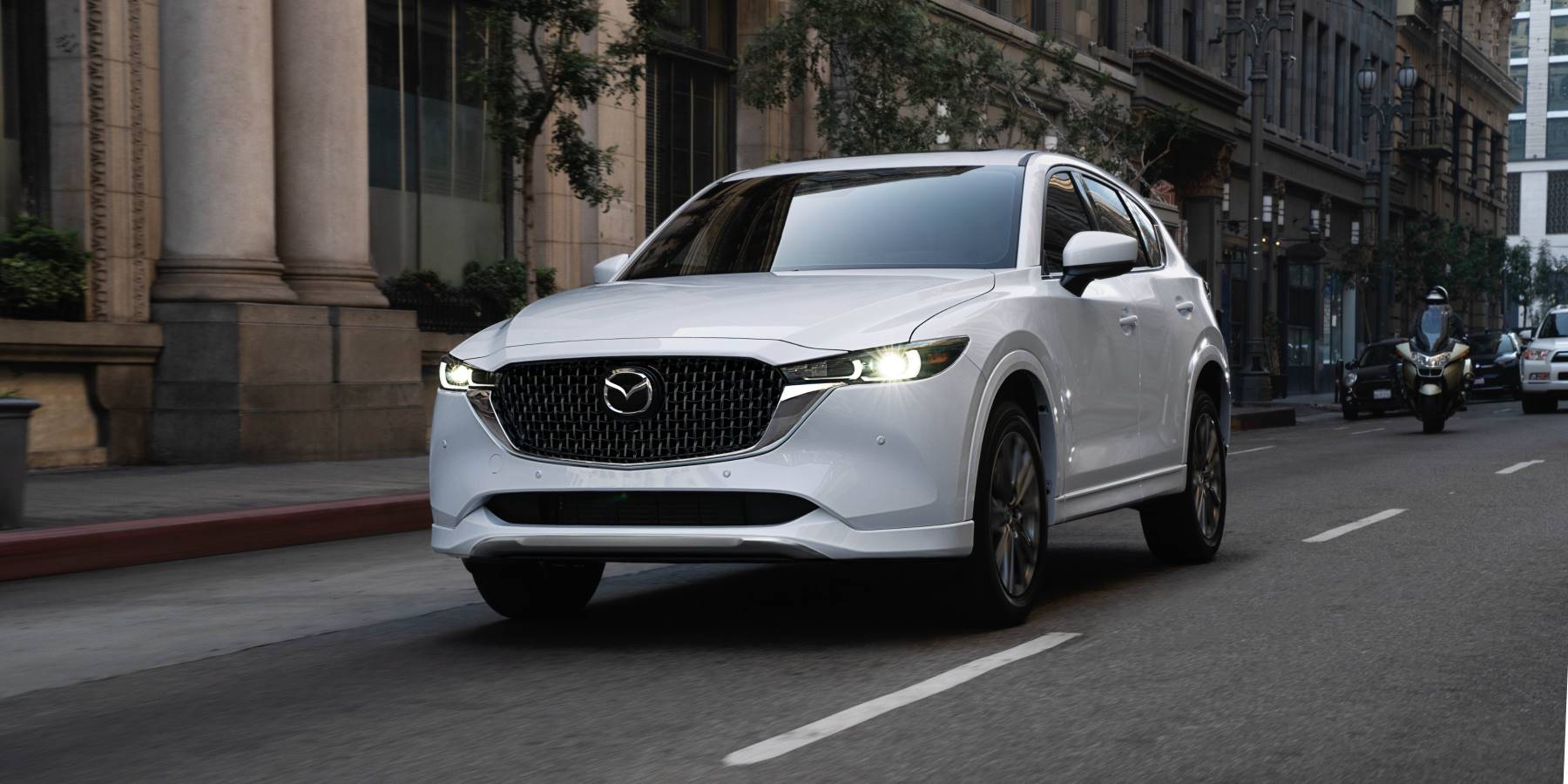 2025 Mazda cx-5 in white driving through city