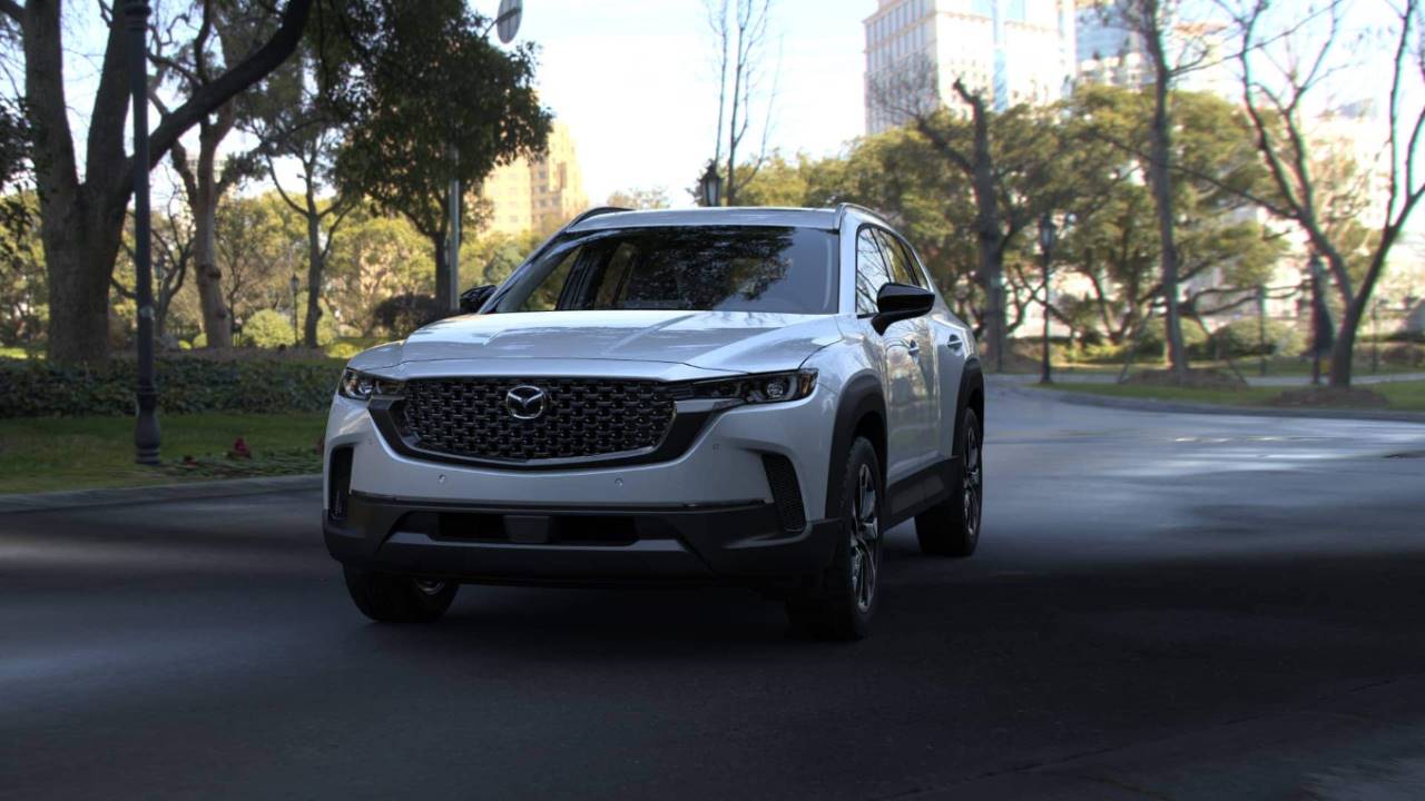 a white mazda cx-50 parked on a paved road